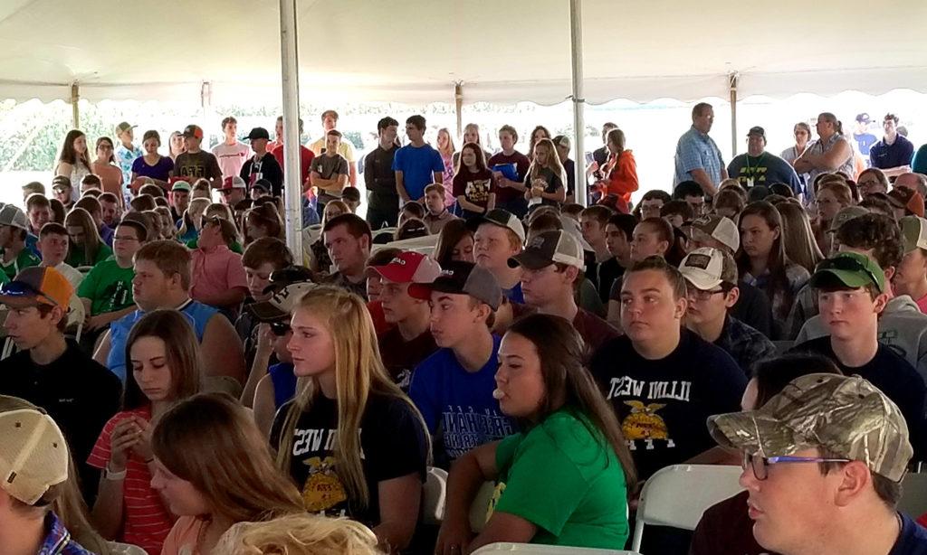 Students in a livestock judging competition crowd